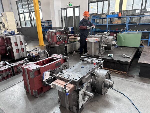 A worker meticulously inspecting KAIBO industrial gear reducers. This scene embodies the troubleshooting process in after - sales services, highlighting the team’s professionalism to guarantee reducer performance.